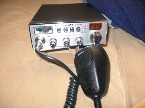 1989 Ford Bronco - A Cobra 25 LTD Classic CB radio with its attached microphone is shown on a tan surface.