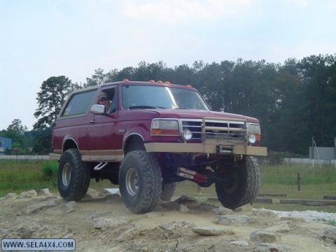 1995 Ford Bronco - This lifted 1995 Ford Bronco navigates a rocky obstacle course with its custom front bumper and winch.