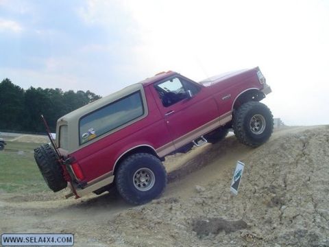 1995 Ford Bronco - This 1995 Ford Bronco is shown tackling an off-road obstacle on a dirt hill.