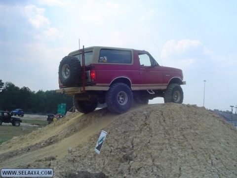 1995 Ford Bronco - This Ford Bronco is tackling an off-road obstacle, its capabilities on a steep dirt incline.