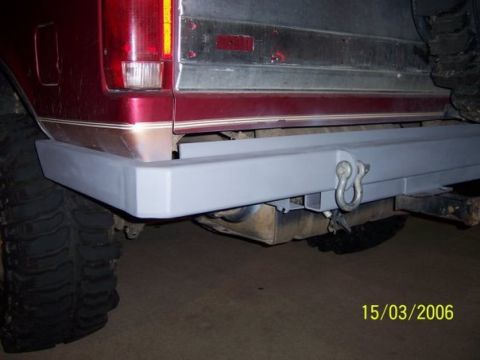 1995 Ford Bronco - Rear view of a 1995 Ford Bronco, showing the bumper and a large tire.