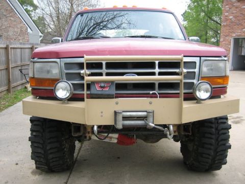 1995 Ford Bronco - This 1995 Ford Bronco features a custom tan bull bar with an integrated winch and auxiliary lights.