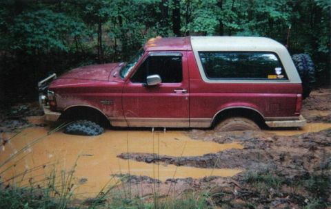 1995 Ford Bronco - This 1995 Ford Bronco is deeply stuck in a muddy off-road trail.