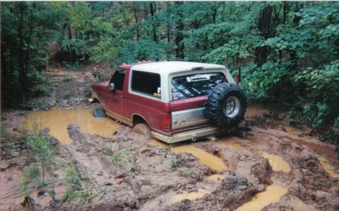 1995 Ford Bronco - This 1995 Ford Bronco is deep in the mud on an off-road trail.