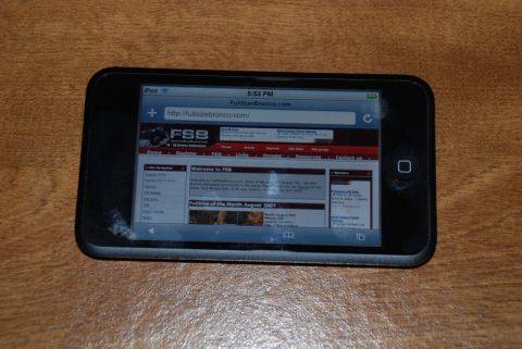1996 Ford Bronco - A smartphone displays a website dedicated to Ford Broncos, with the URL visible in the browser bar.