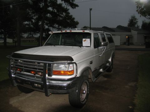 1978 Ford Bronco - This white Ford Bronco SUV, likely a 1992 model, is parked in a driveway at twilight.