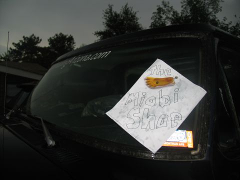 1978 Ford Bronco - A sign is taped to the windshield of a dark vehicle.