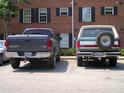 1989 Ford Bronco - Rear view of a 1992 Ford Bronco parked next to a Dodge pickup truck.
