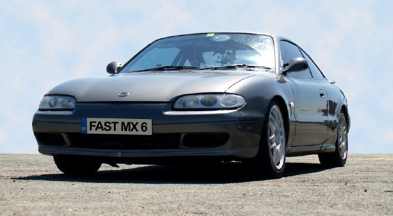 Gray Mazda MX-6 with license plate FAST MX 6