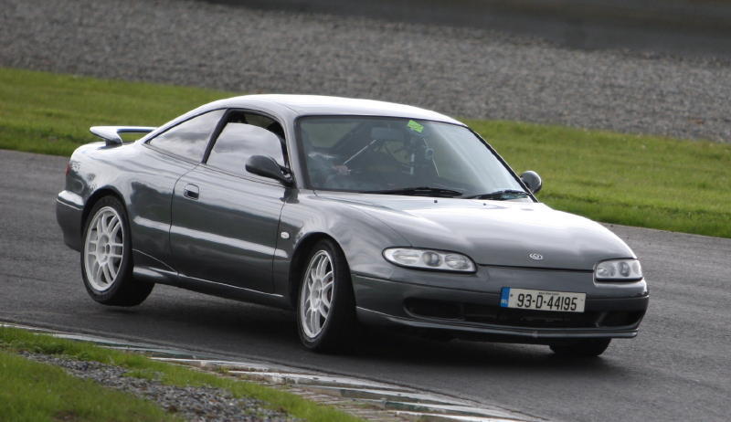 Gray Mazda MX-6 on a race track. License plate reads 93-D-44195