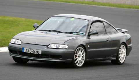 1991 Ford Probe - This 1991 Ford Probe is captured on a racetrack, white wheels and an Irish license plate.