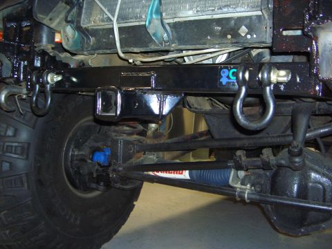 1996 Ford Bronco - Close-up view of the front undercarriage of an off-road vehicle, highlighting its suspension and recovery points.