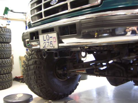 1996 Ford Bronco - Front view of a green Ford truck with a chrome grille and large tires, displaying license plate LO-275.