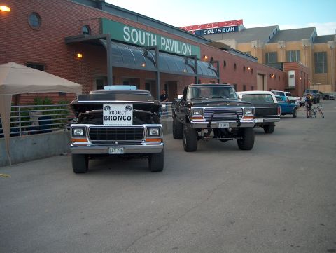 1978 Ford Bronco - Two Ford trucks, one a Bronco with its hood open, are parked outside a building labeled "SOUTH PAVILION" at the Indiana State Fair Coliseum.