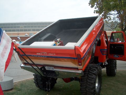 1978 Ford Bronco - This modified Ford pickup truck features a dump bed and custom paint with a humorous slogan.