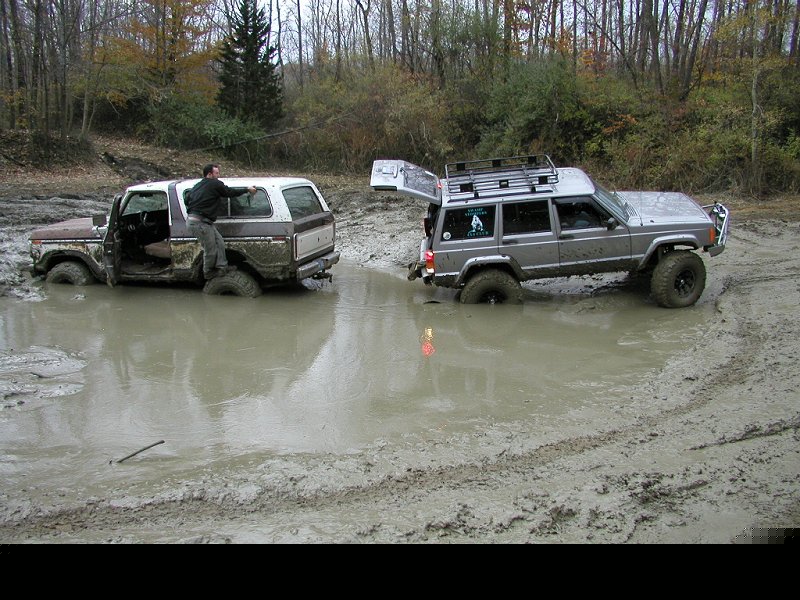 1978 Ford Bronco stuck in mud with a Jeep Cherokee