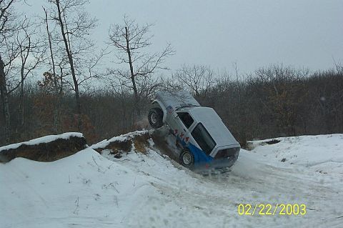 1978 Ford Bronco - This 1978 Ford Bronco is navigating a challenging snowy terrain, showing its off-road capabilities.