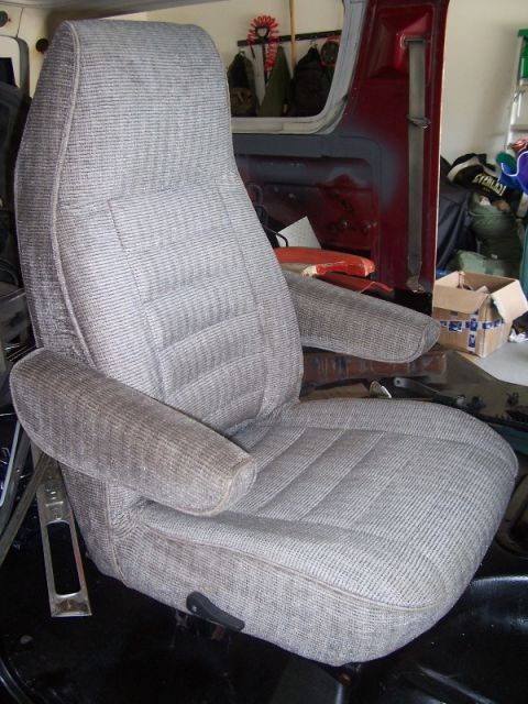 1978 Ford Bronco - A close-up view of a single vehicle seat, showing its fabric texture and armrests.