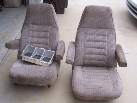 1978 Ford Bronco - Two car seats are shown, one with a gauge cluster housing placed on it.