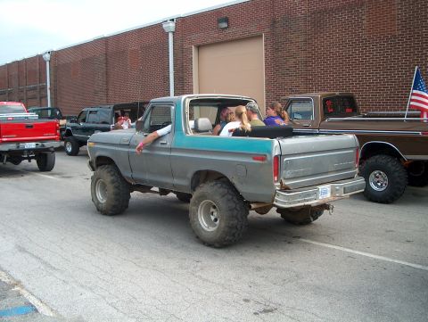 1978 Ford Bronco - Modified 1978 Ford Bronco with lifted suspension and large tires, seen with other trucks.