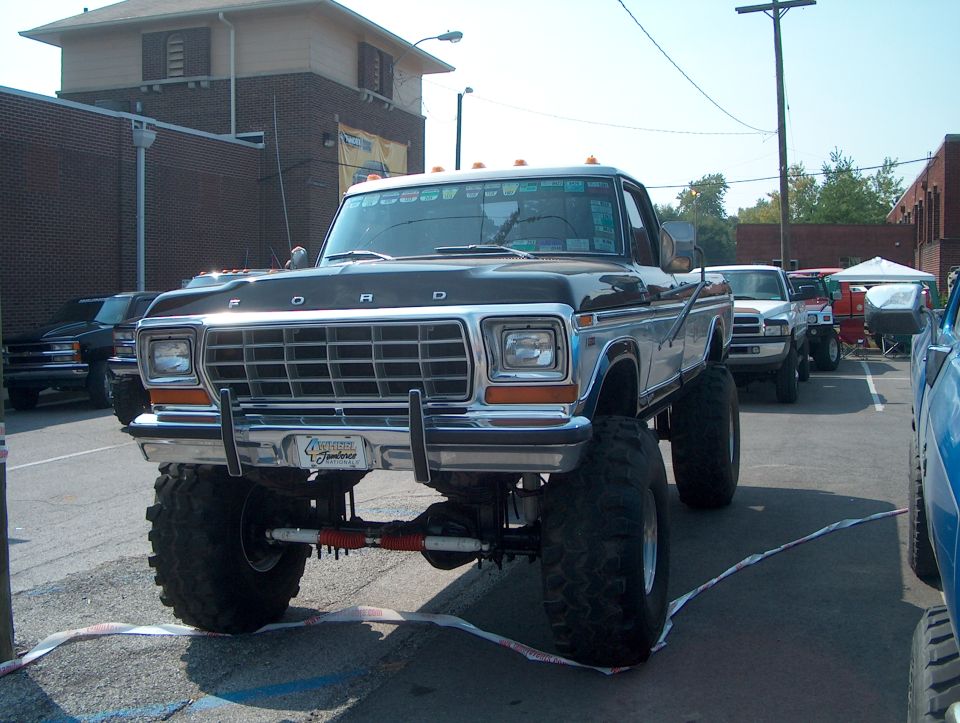 Black and chrome lifted Ford F-Series truck, front view, with large tires and a custom bumper