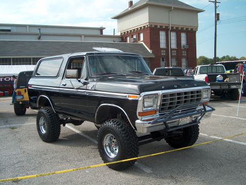 1978 Ford Bronco - This lifted 1978 Ford Bronco features a prominent grille and aftermarket front bumper, seen parked outdoors.