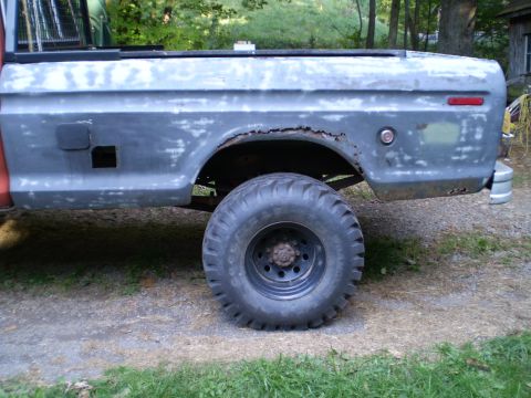1979 Ford Bronco - The rear quarter panel and bed of a Ford F-Series truck, showing signs of rust and bodywork.