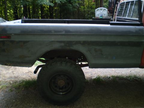 1979 Ford Bronco - This image shows the side profile of a pickup truck, focusing on the bed and rear wheel. The vehicle's body style suggests it is from the l…