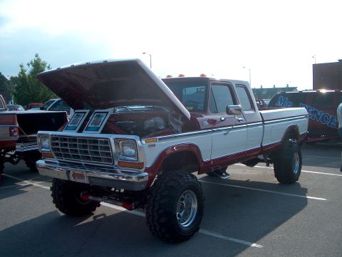 1978 Ford Bronco - Modified 1978 Ford F-Series pickup truck displayed with its hood open, parked next to another vehicle.