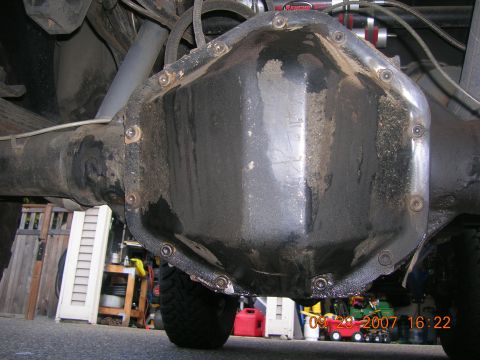 1996 Ford Bronco - The rear differential cover shows signs of wear and tear, with some dirt and grime accumulated.