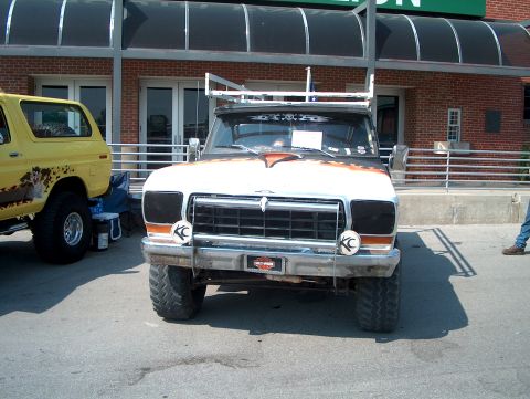 1978 Ford Bronco - A modified 1970s Ford F-Series truck is parked next to a yellow Ford Bronco.