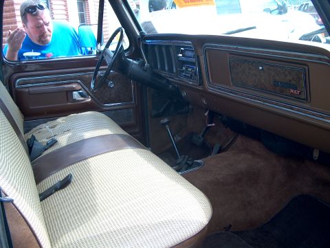 1978 Ford Bronco - The interior of a 1978 Ford Bronco XLT shows off its tan and brown patterned seats and wood-grain dashboard trim.