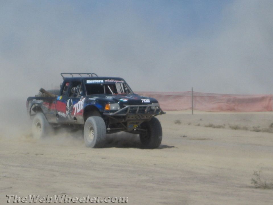 Dark off-road trophy truck number 706 racing in the desert