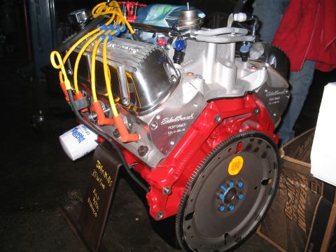 1989 Ford Bronco - A V8 engine with chrome valve covers and red block is displayed with yellow spark plug wires.