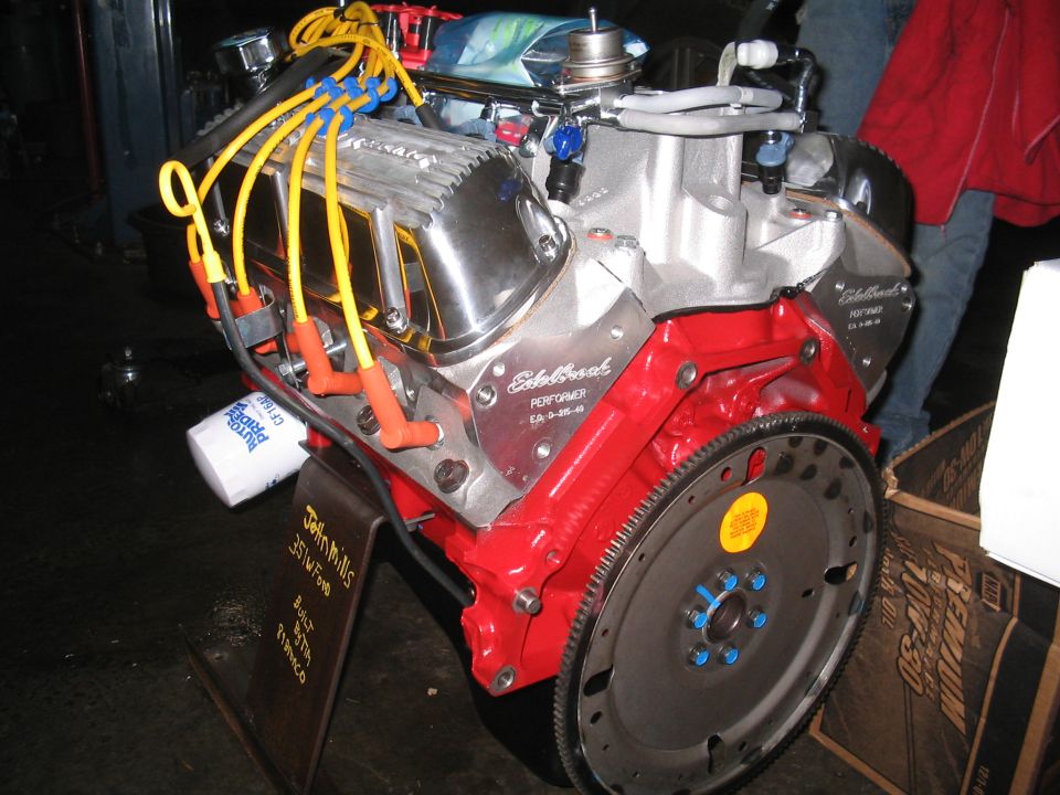 Chrome and red V8 engine with yellow spark plug wires and an oil filter