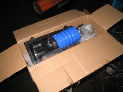 1989 Ford Bronco - New air intake components are packed in a cardboard box, ready for installation.