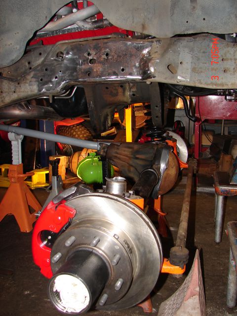 1989 Ford Bronco - Close-up of a Dana 60 front axle assembly, showing the brake components and suspension linkage.