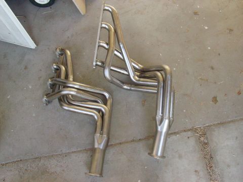 1979 Ford Bronco - Exhaust headers are visible on a concrete surface, with a watermark at the bottom right.