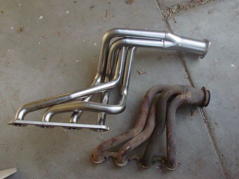 1979 Ford Bronco - Comparison of a new exhaust manifold next to an old, rusted one.