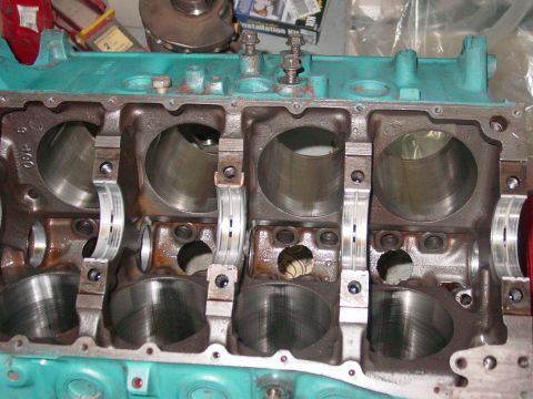 1979 Ford Bronco - Close-up view of a teal engine block, showing the cylinder bores and bearing caps.