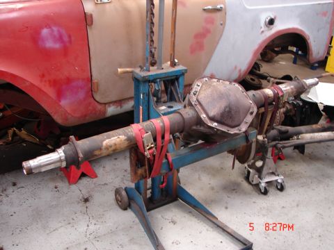 1989 Ford Bronco - Rear axle assembly supported by a stand, with a vehicle body in the background.