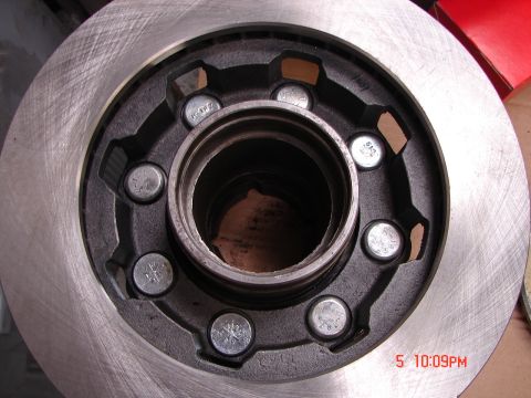 1989 Ford Bronco - Close-up of a brake rotor and hub assembly, with visible lug nuts and a central bearing race.