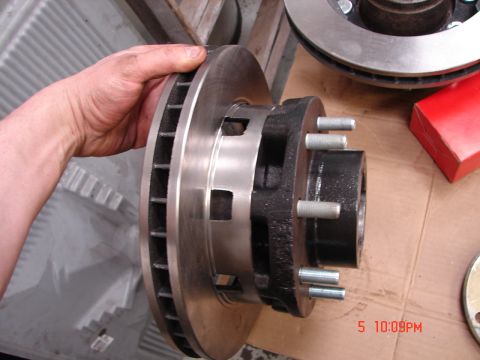 1989 Ford Bronco - A hand holds a brake rotor and hub assembly, with a timestamp of 5 10:09PM visible in the corner.
