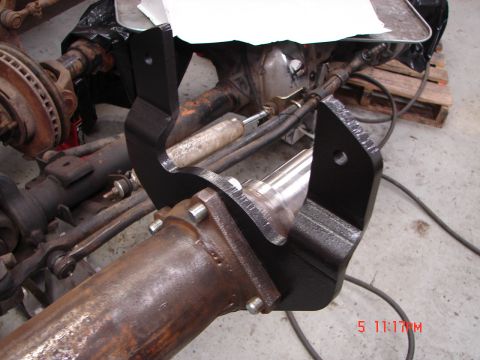 1989 Ford Bronco - Close-up of a vehicle's rear axle assembly, focusing on a newly installed black metal bracket.