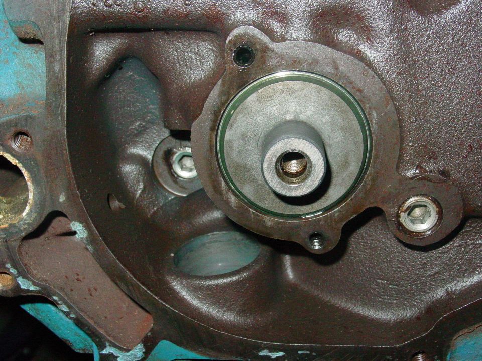 Close-up of an engine block with a circular component attached