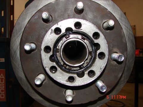 1989 Ford Bronco - Close-up view of a vehicle's wheel hub and brake rotor assembly, revealing internal components and grease.