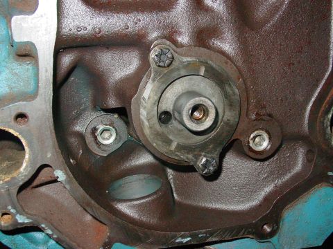 1979 Ford Bronco - Detail of an engine's timing cover assembly, showing the mechanism and mounting bolts.