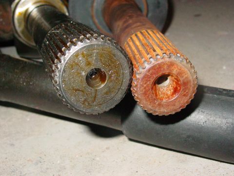 1979 Ford Bronco - Comparison of two splined shafts, one showing significant rust and wear.