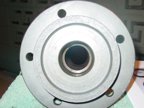 1979 Ford Bronco - A metal hub component is shown in a close-up view, with visible bolt holes and a central bore.