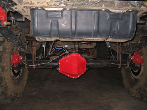 1989 Ford Bronco - Underside view of a vehicle's rear axle assembly, showing suspension and braking components.